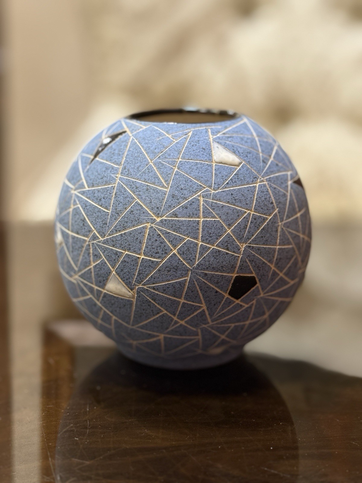 Small spherical ceramic studio vase from a Lviv studio, glazed in mottled tones.