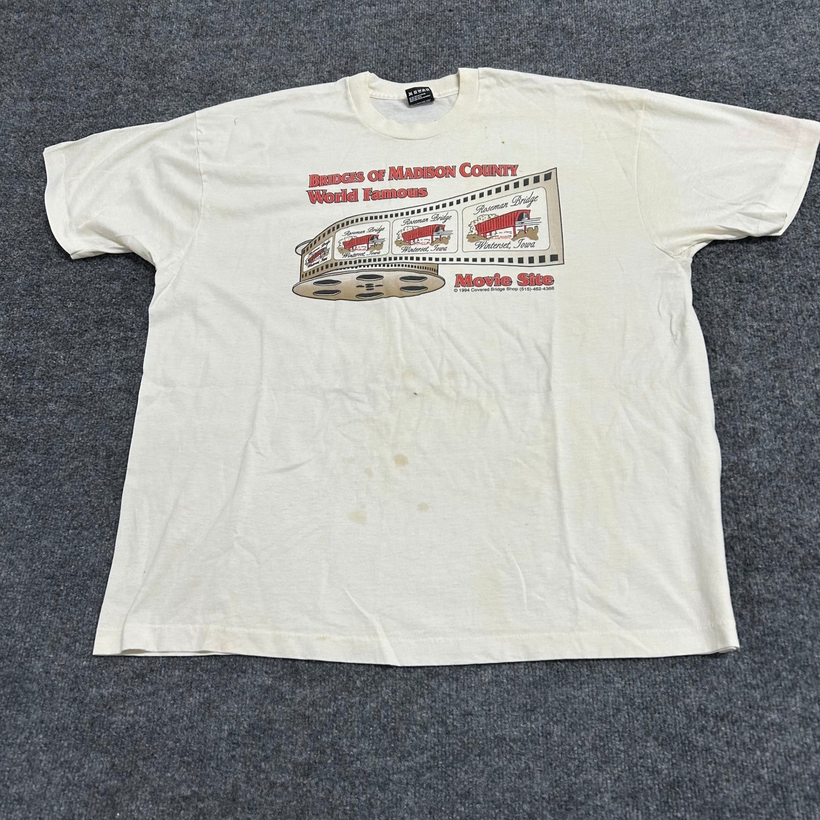 Cream Fruit of the Loom men’s XXL T-shirt with “Bridges of Madison County USA” text and red filmstrip graphic on front.