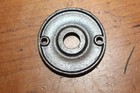 Round antique cast iron doorknob escutcheons with smooth center and brushed texture on the flat metal plate.