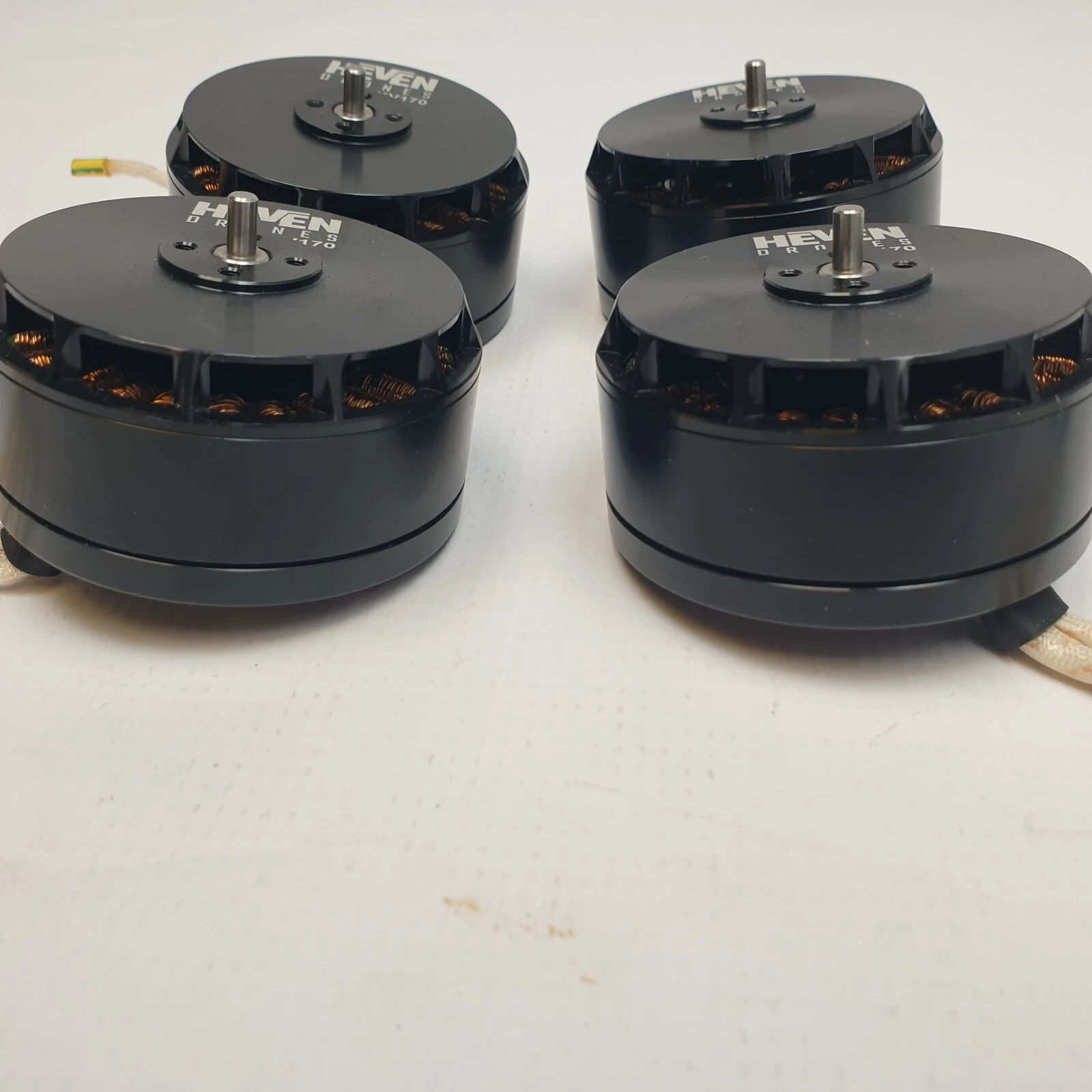 Four black KV170 motors from the side, showing shafts and vented housings