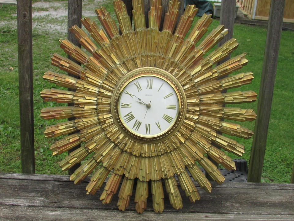 A massive 23" 1969 Syroco sunburst atomic clock — Syroco's ornate composite material gives it a texture and presence no modern repro can fake.