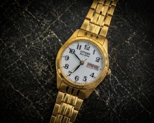 Citizen Eco-Drive Gold Tone Bracelet Watch White Dial Day/Date Arabic Numerals