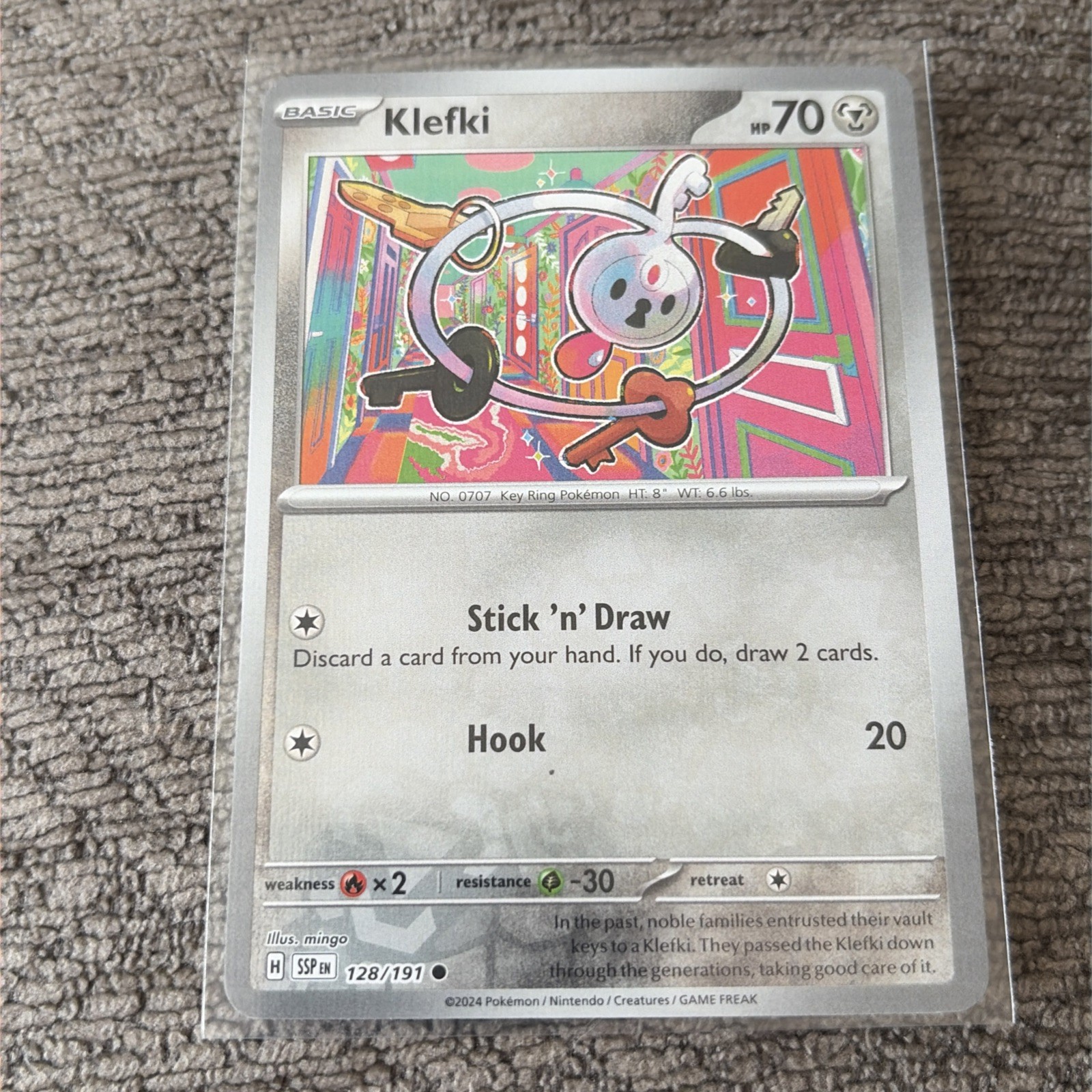 Klefki 128/191 Surging Sparks Near Mint Reverse Holo Pokemon Card