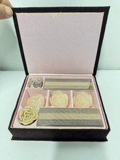 gift box containing rose-shaped candles.