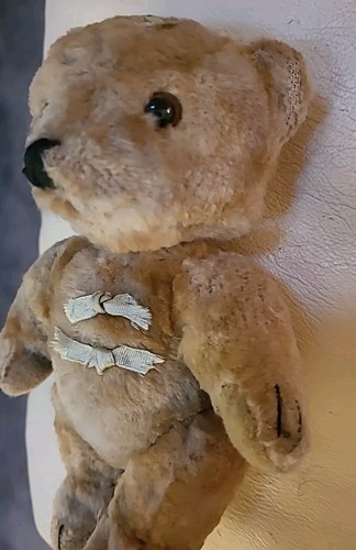 A miniature Schuco teddy bear 1920s, with golden mohair, black pin eyes