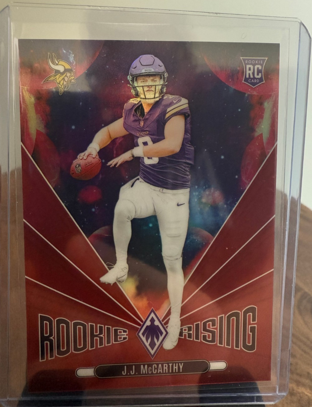 2024 Panini Phoenix - Rookie Rising J.J. McCarthy #RR-JMY Red /99 (RC)