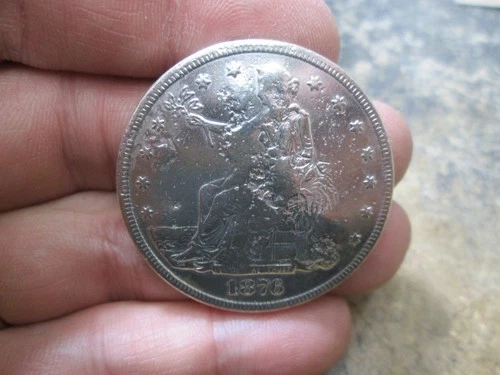 1876 US SEATED LIBERTY SILVER TRADE DOLLAR IN FINE CONDITION  DENTED & CHOP MARK
