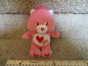 pink care bear with two hearts