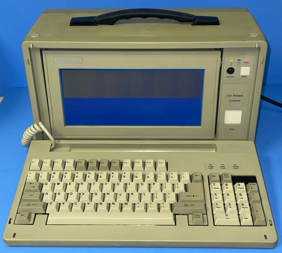 An actual working (or display-worthy) LCD-286 portable computer from the late 80s — a proper museum piece that still looks futuristic in a retro way.