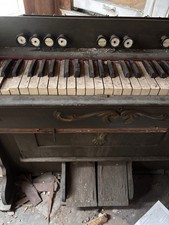 Antique Pump Organ with Foot Pedals and Decorative Cherub Motif