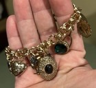 gold-tone charm bracelet 11 Charms Including 2 Lockets