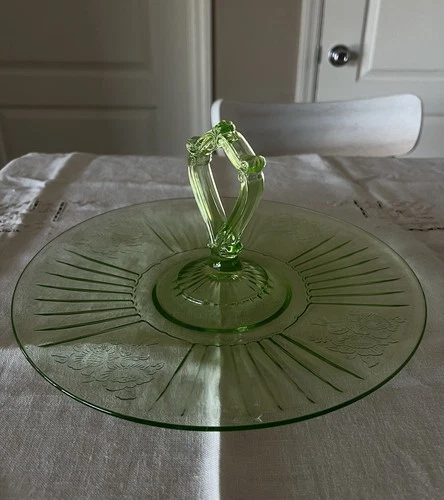 vintage Uranium green Depression glass sandwich server with a center handle.