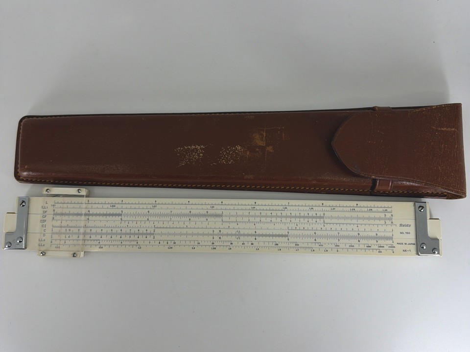 A genuine bamboo slide rule from Japan with its original leather case — a beautifully tactile pre-digital calculator that doubles as a desk art piece.