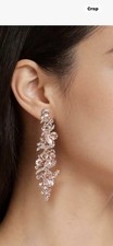 Crystal Rose Gold Chandelier Earrings Feature a Leaf Pendant Design.