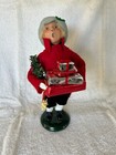 2005 Byers Choice Child Caroler holding Christmas gifts, wreath on arm 10”