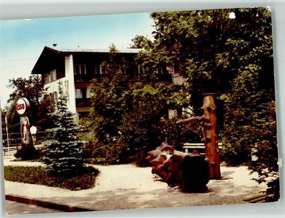 38017242 - 8201 Bad Feilnbach Tree Trunk Fountain Next to Esso Gas Station Photo