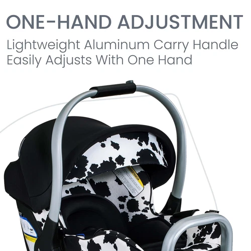 Black and white cow-print Britax Willow SC infant car seat with silver aluminum carry handle and one-hand adjustment feature.