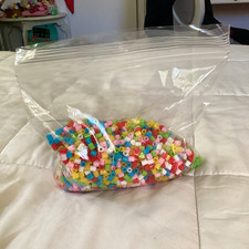 Red, blue, white, green, pink, and yellow perler beads. With a little surprise