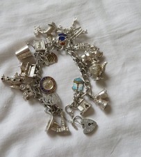 Silver charm bracelet with 20 charms -includes opening pig,church, gypsy caravan