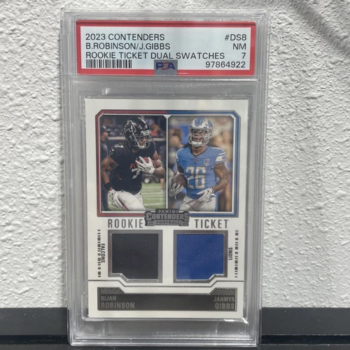 2023 Panini Contenders - Rookie Ticket Dual Swatches #DS-8 Jahmyr Gibbs, Bijan Robinson (MEM, RC)