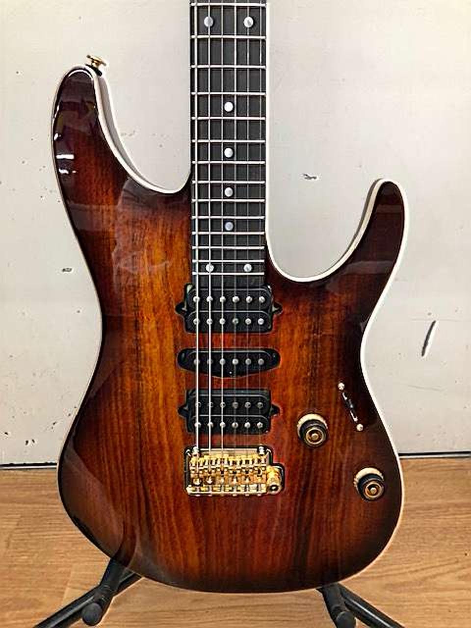 Ibanez AZ47P2K Dragoneyeburst used electric guitar with gold hardware, black pickguard, and three single-coil pickups.
