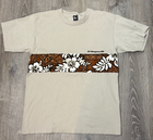 Beige Y2K VTG T&C surf shirt with brown and white floral overlay, “Y2K VTG T&C” logo on chest, USA Made.
