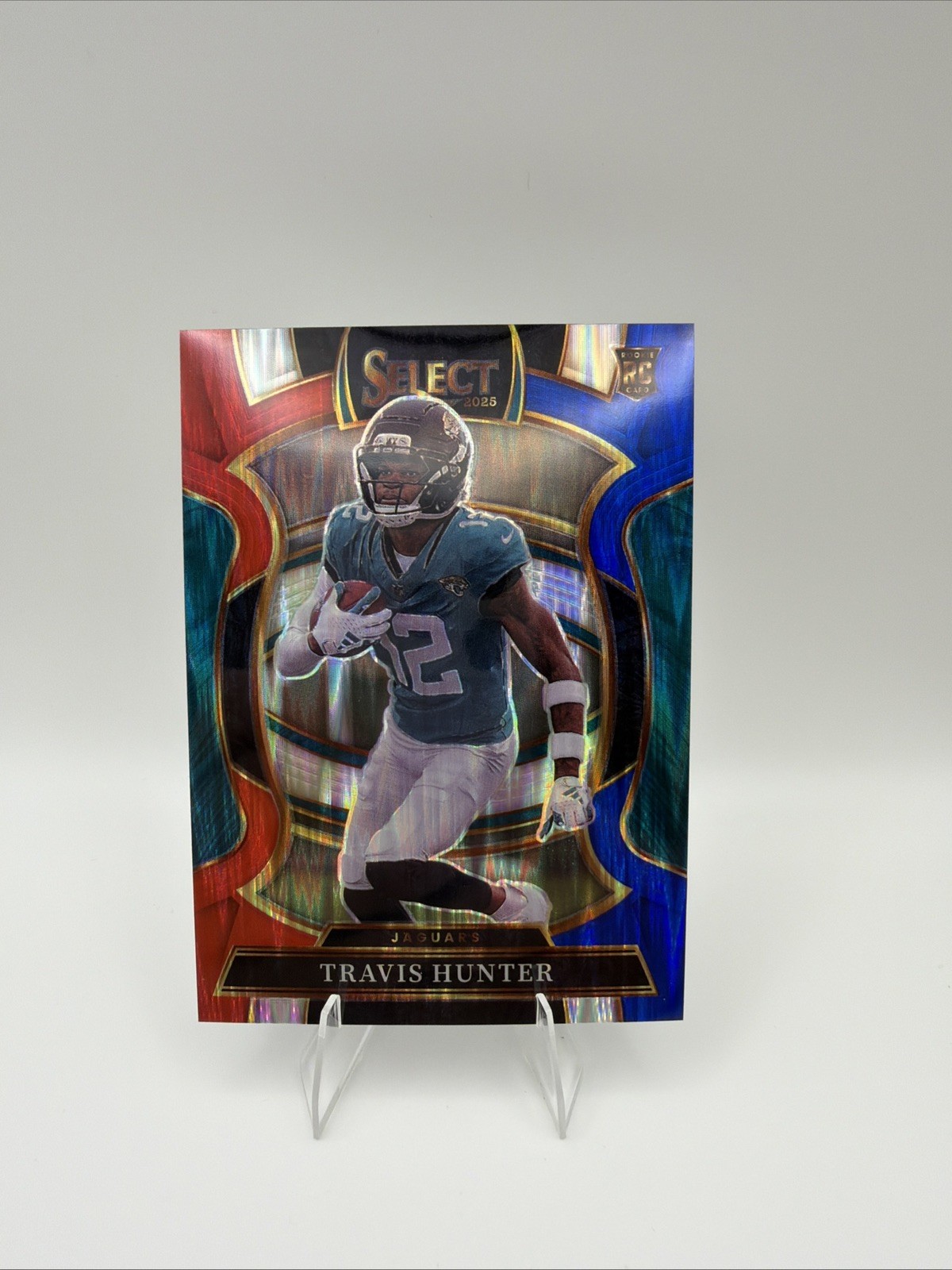 2025 Panini Select Travis Hunter (RC) #128 Red And Blue Prizm Shock Jaguars