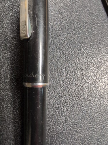 Black Eversharp mechanical pencil with silvertone trim, blue nib, and subtle “Eversharp” logo on textured grip section.