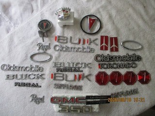 MIXED LOT OF NOS AND USED EMBLEMS AND PARTS LOT; OLDS BUICK FORD CADILLAC
