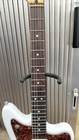 White SQUIER VATAGE MOD JAGER electric guitar with gold hardware, black pickguard, and six chrome strings on metal fretboard.