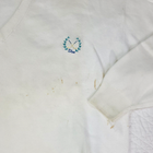 White VTG Christian Dior men’s V-neck sweater with blue embroidered logo and crosshatches on chest, made in USA.