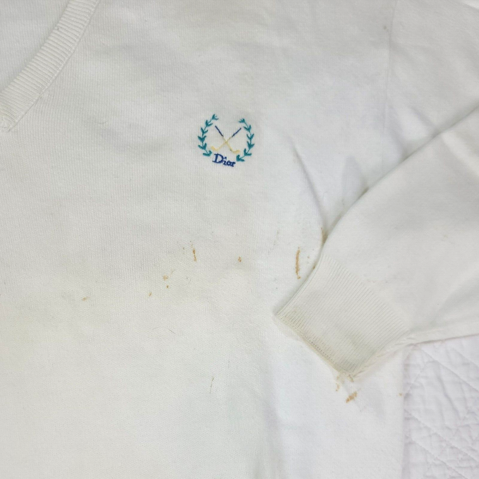 White VTG Christian Dior men’s V-neck sweater with blue embroidered logo and crosshatches on chest, made in USA.
