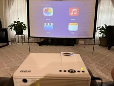 RCA RPJ116 Home Theater Projector with remote and projector screen/ stand