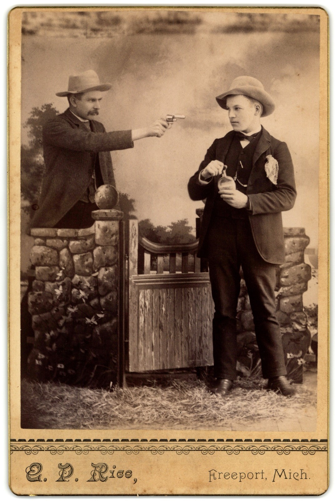 CABINET CARD E.P. RICE MAN POINTING REVOLVER AT MAN HOLDING LIQOUR WILD WEST ERA