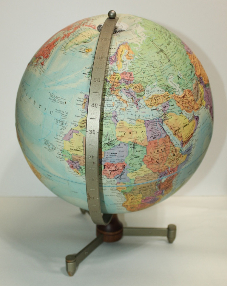 A mid-century Replogle 12" stereo relief globe on a metal and wood base — the kind of desktop statement piece that makes a study look like a 1960s professor's office.