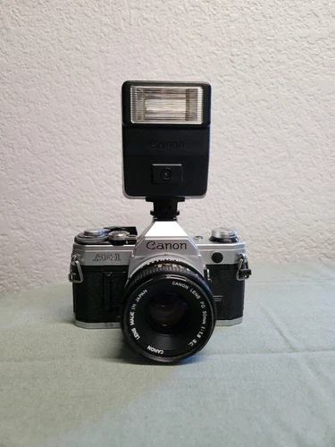 Canon AE-1 Black and Silver with Speedflash 155A Flash Vintage Camera