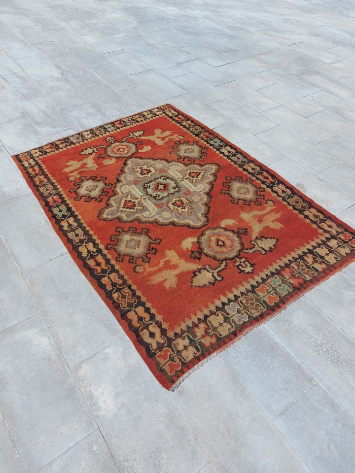 A rare antique Oushak kilim blending floral and geometric patterns — the kind of one-of-a-kind floor piece that instantly becomes the soul of a room.