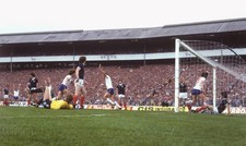 Paul Mariner follows ball into net after scoring England's match w- Old Photo