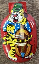 VINTAGE - TIN LITHO - 1960'S - - CLICKER - TIGER PLAYING INSTRUMENT - JAPAN -