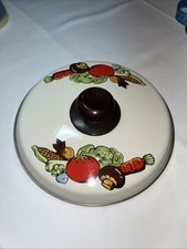 1970s enamel cookware lid featuring a colorfu...