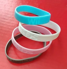 Four authentic silicon Nintendo Wii and DS bracelets, never used