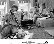 James Caan on phone as Lauren Hutton watches from the bed from the- Old Photo