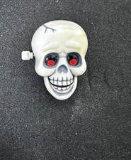 Vintage, 1985 Plastic Hallmark Halloween Chattering Skull Wind-up Pin/Brooch