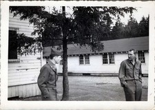 WW2 Photo of Two Soldiers Talking Between Barracks Buildings