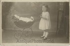 Cute girl child with doll in toy carriage antique rppc photo
