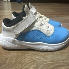 Air Jordan 11 CMFT Low sneakers in the "UNC" white and baby blue colorway.