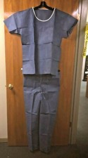 DISPOSABLE SCRUB SHIRTS AND PANTS. NEW IN BOX. SEALED. 50 EACH PER CASE