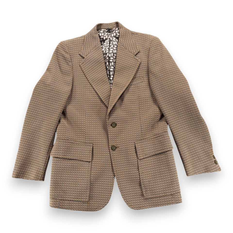 A proper 1970s houndstooth blazer with a wild novelty lining — the kind of thrifted score fashion-forward people pay boutique prices for.