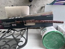 Red and gold katana with Black Blade. Blade is sharp. In good condition.