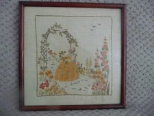 Edwardian/Victorian embroidered sampler of a lady in a garden sampler